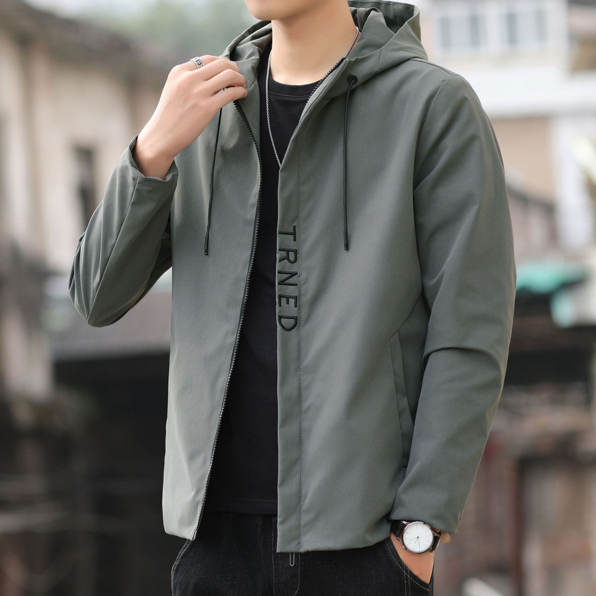 Men's lightweight hooded shell jacket with concealed zipper and minimalist utility look Shop Velvia