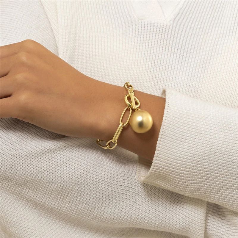 Women's link bracelet with ball pendant in gold appearance