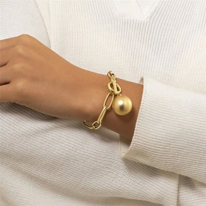 Women's link bracelet with ball pendant in gold appearance
