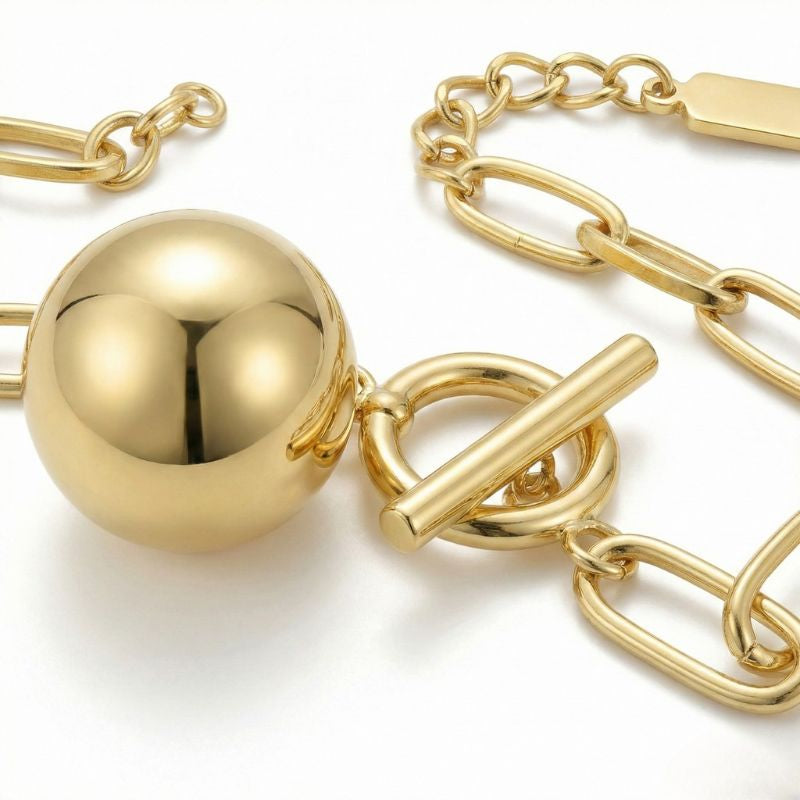 Women's link bracelet with ball pendant in gold appearance