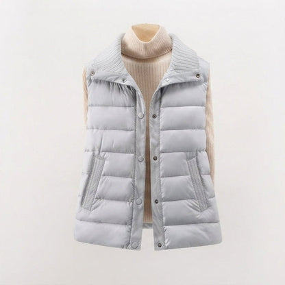 Women's non-padded quilted gilet with high ribbed shawl collar and concealed snap button placket