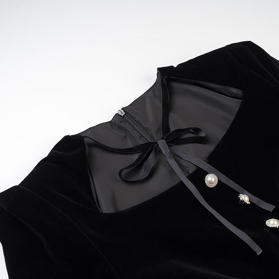 Women’s velvet dress with fitted bodice, puff sleeves, and layered ruffle skirt Shop Velvia