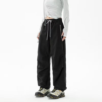 Loose trekking pants with water-repellent quick-drying coating, elastic drawstring waist, and zippered pockets Shop Velvia