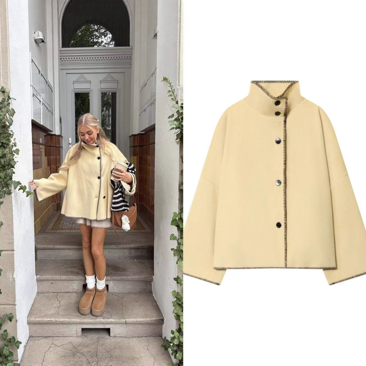 Women's short cape coat with stand collar, contrasting decorative stitch edge, and oversized sleeves Shop Velvia