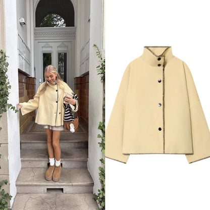 Women's short cape coat with stand collar, contrasting decorative stitch edge, and oversized sleeves Shop Velvia
