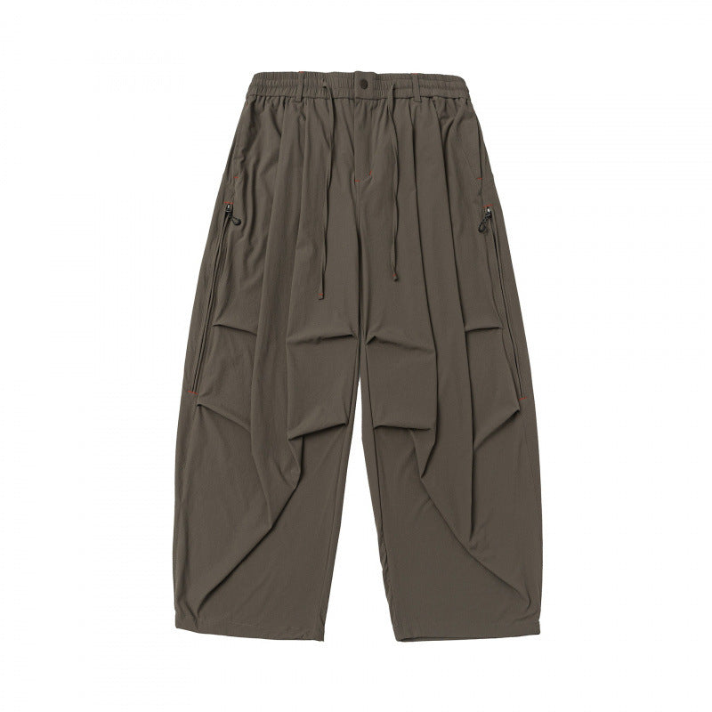 Unisex Loose-fitting technical cargo pants with elastic waistband, drawstring, and zip pockets Shop Velvia