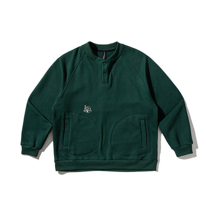Unisex Oversize Henley Sweatshirt with raglan sleeves, button placket, and distinctive round pockets Shop Velvia