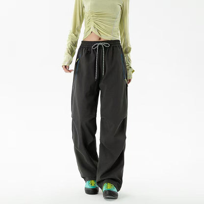 Loose trekking pants with water-repellent quick-drying coating, elastic drawstring waist, and zippered pockets Shop Velvia