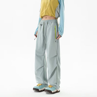 Loose trekking pants with water-repellent quick-drying coating, elastic drawstring waist, and zippered pockets Shop Velvia