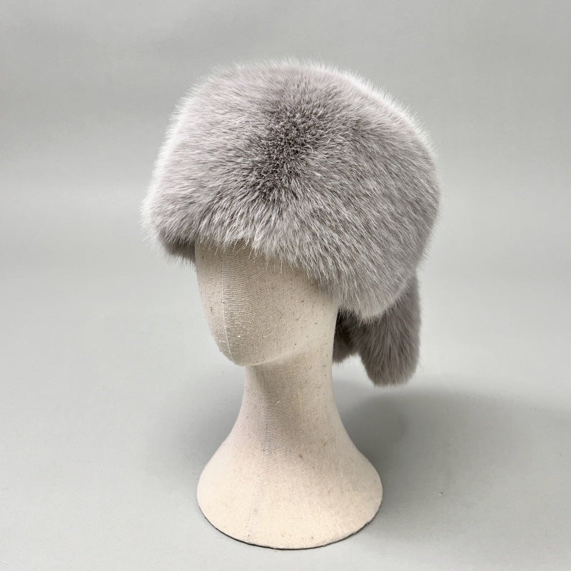 Women’s plush faux fur trapper hat with earflaps and decorative tail Shop Velvia