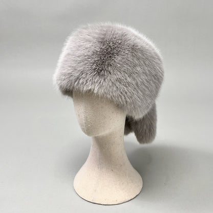 Women’s plush faux fur trapper hat with earflaps and decorative tail Shop Velvia
