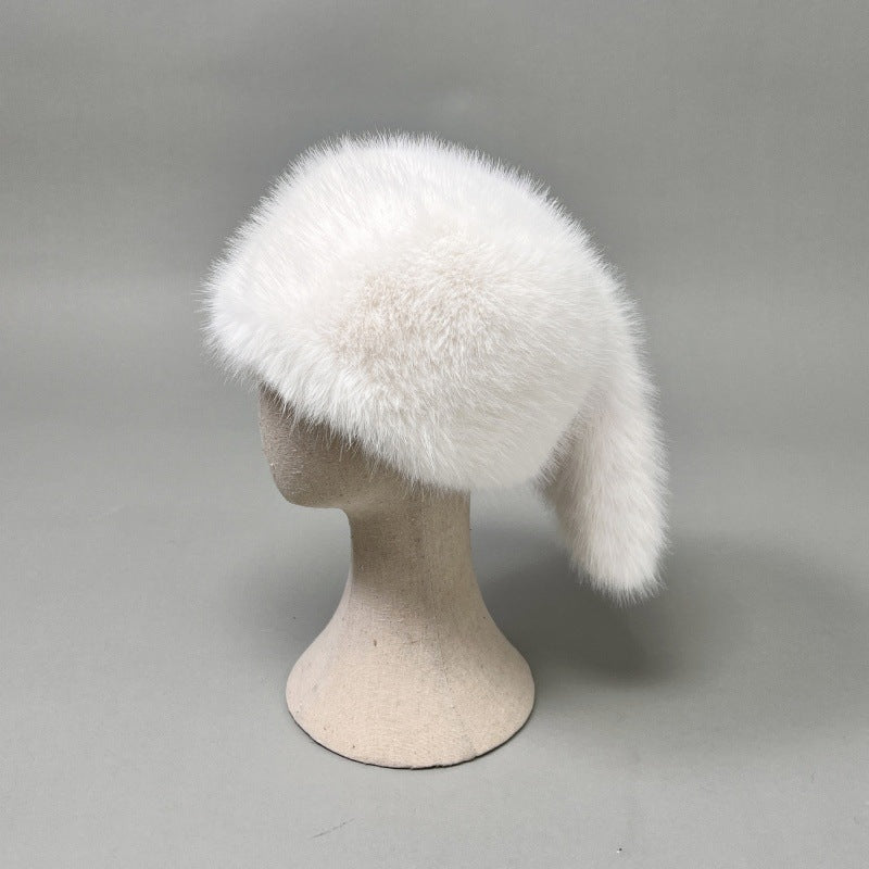 Women’s plush faux fur trapper hat with earflaps and decorative tail Shop Velvia