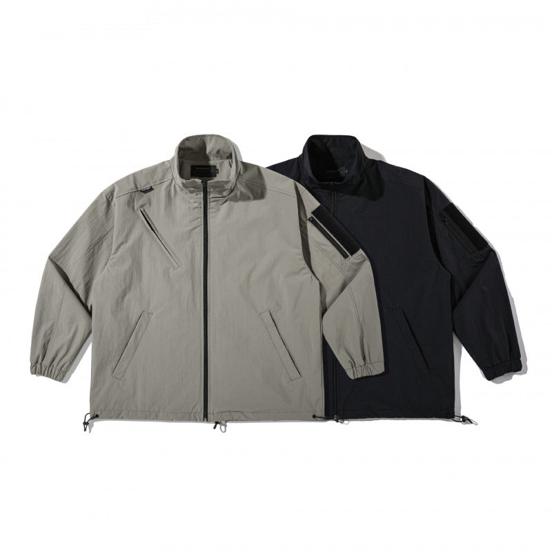 Unisex Lightweight Technical-Utility Jacket with Stand Collar, Zipper Pockets and Drawstring Hem Shop Velvia
