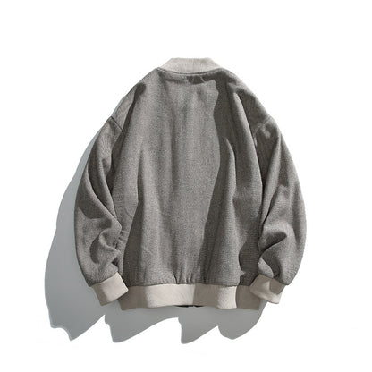 Unisex boxy bomber jacket in herringbone look with ribbed cuffs, flap pockets, and concealed snap button placket Shop Velvia