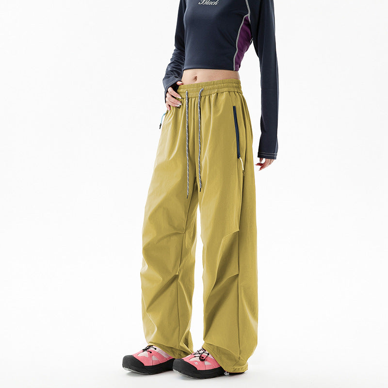 Loose trekking pants with water-repellent quick-drying coating, elastic drawstring waist, and zippered pockets Shop Velvia