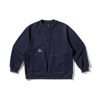 Unisex Oversize Henley Sweatshirt with raglan sleeves, button placket, and distinctive round pockets Shop Velvia