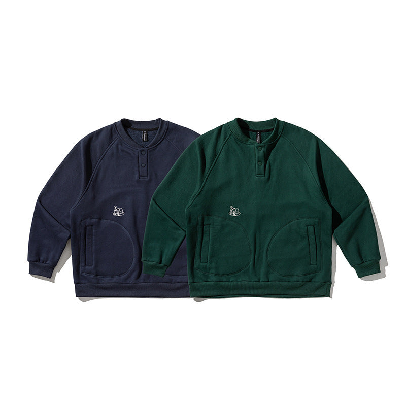 Unisex Oversize Henley Sweatshirt with raglan sleeves, button placket, and distinctive round pockets Shop Velvia