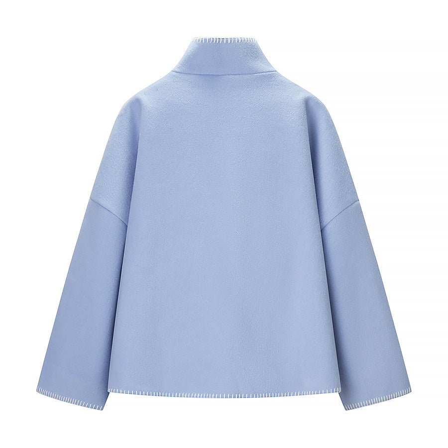 Women's short cape coat with stand collar, contrasting decorative stitch edge, and oversized sleeves Shop Velvia