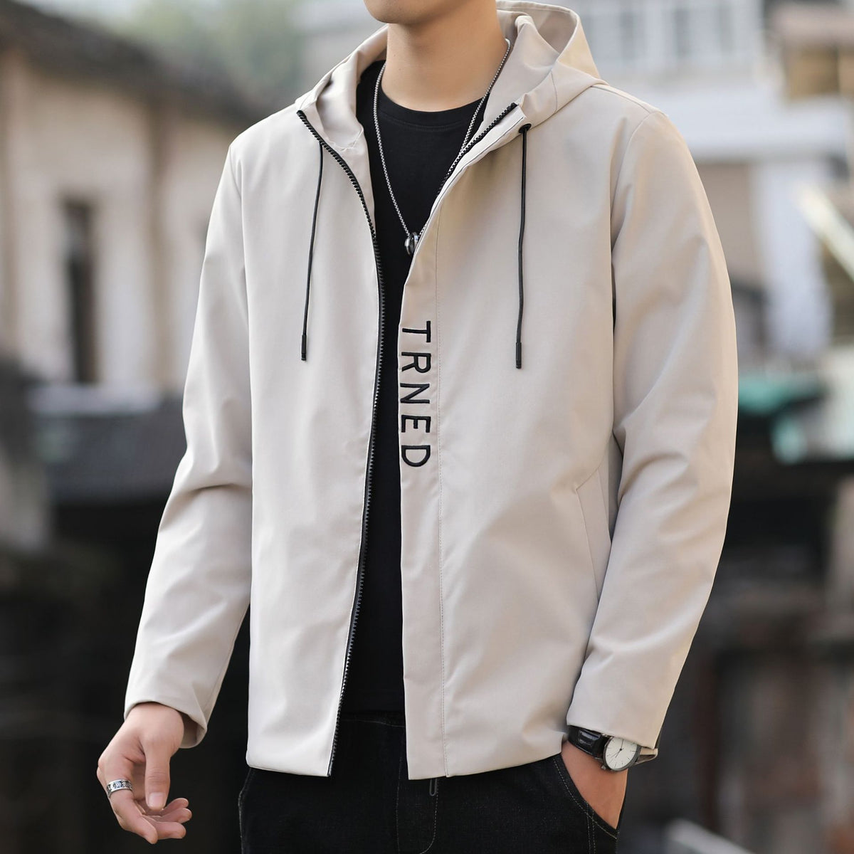 Men's lightweight hooded shell jacket with concealed zipper and minimalist utility look Shop Velvia